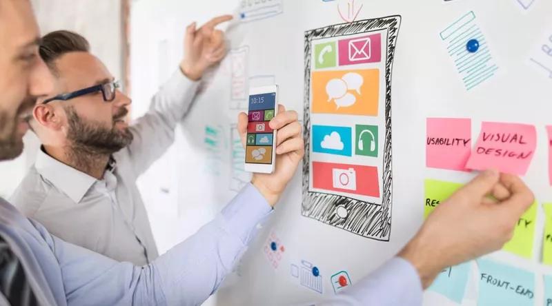 Two designers examining elements of an app